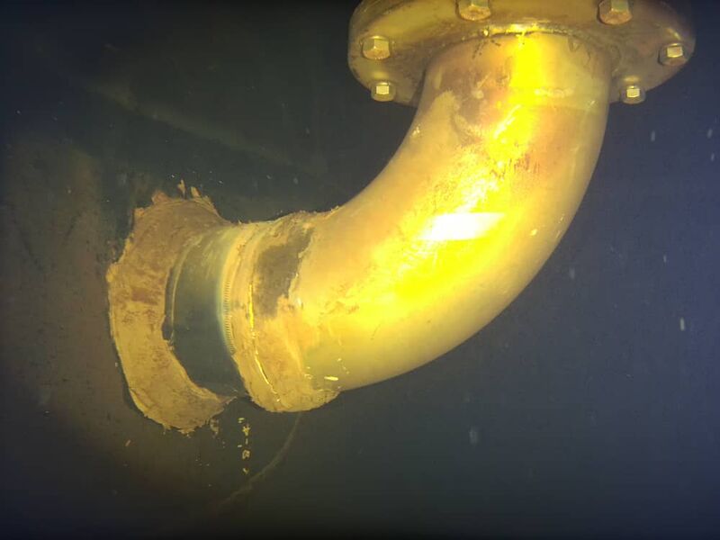 Flanged outlet elbow pipe inspected underwater inside a tank